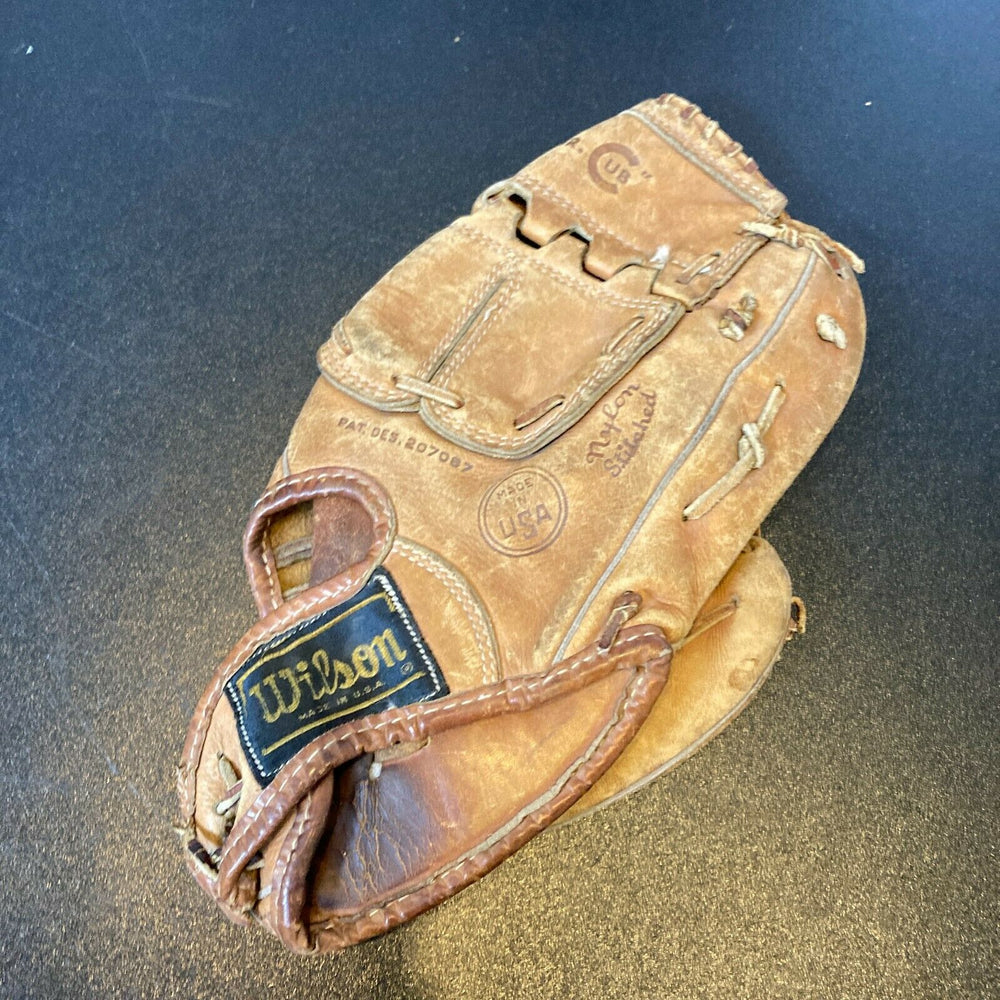 Old baseball glove and ball. An old baseball glove (1950 s Roy